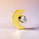 Instinct gold titanium crescent moon labret piercing with a clear crystal accent. Internally threaded.