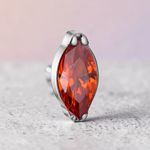 Instinct silver titanium labret with internal thread and a marquise-cut orange gemstone.