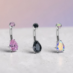 Instinct silver titanium belly button ring with pear-cut double gemstones in purple, yellow, clear, pink, black, and iridescent.