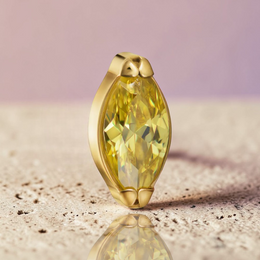 Instinct gold titanium labret piercing with internal threading and a marquise-cut yellow gemstone.