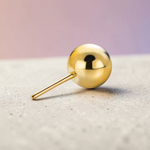 Instinct gold-tone titanium labret piercing with a 2.5mm ball end and push-in design.