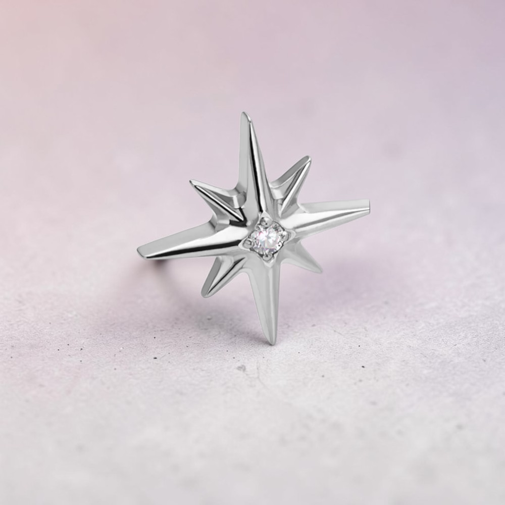 Instinct silver and gold titanium labret with internal thread, featuring a North Star design with a central crystal.