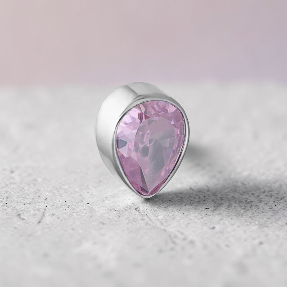 Instinct silver titanium labret with a pink teardrop-shaped crystal, internal thread.