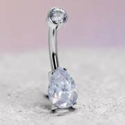 Instinct silver titanium belly button ring with clear round and teardrop cubic zirconia stones.