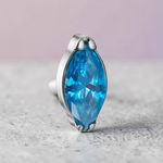 Instinct silver titanium labret with internal thread and a blue marquise-cut gemstone.