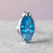 Instinct silver titanium labret with internal thread and a blue marquise-cut gemstone.