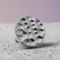 Instinct silver titanium labret piercing with a hammered disc top.