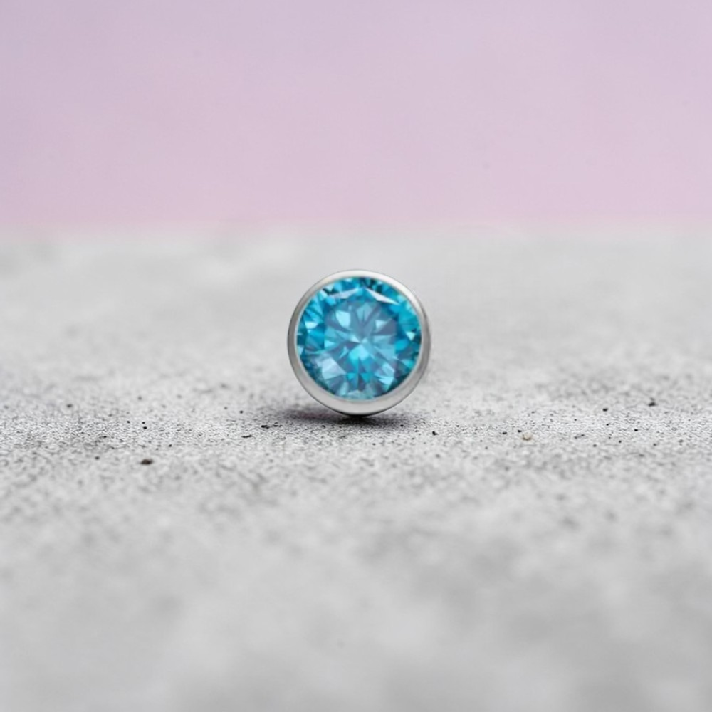 Instinct silver titanium push-in labret with small multicolor stones. Features a clear CZ gem and various colored gems.