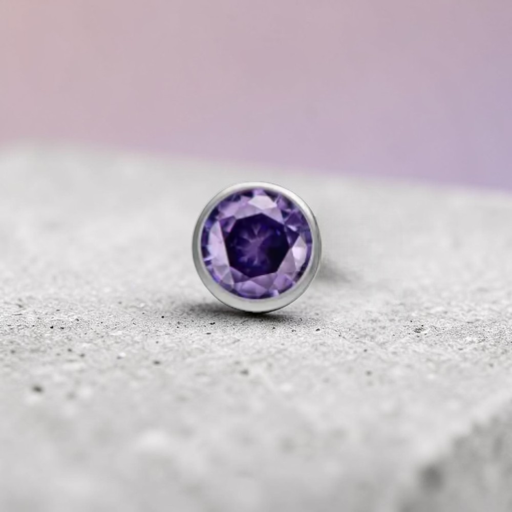 Instinct silver titanium push-in labret with small multicolor stones. Features a clear CZ stone and various colored gems.