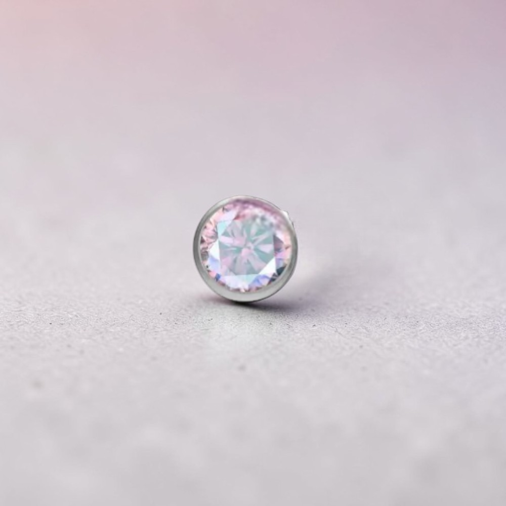 Instinct silver titanium push-in labret with small multicolor stones. Features a clear CZ and various colored gems.
