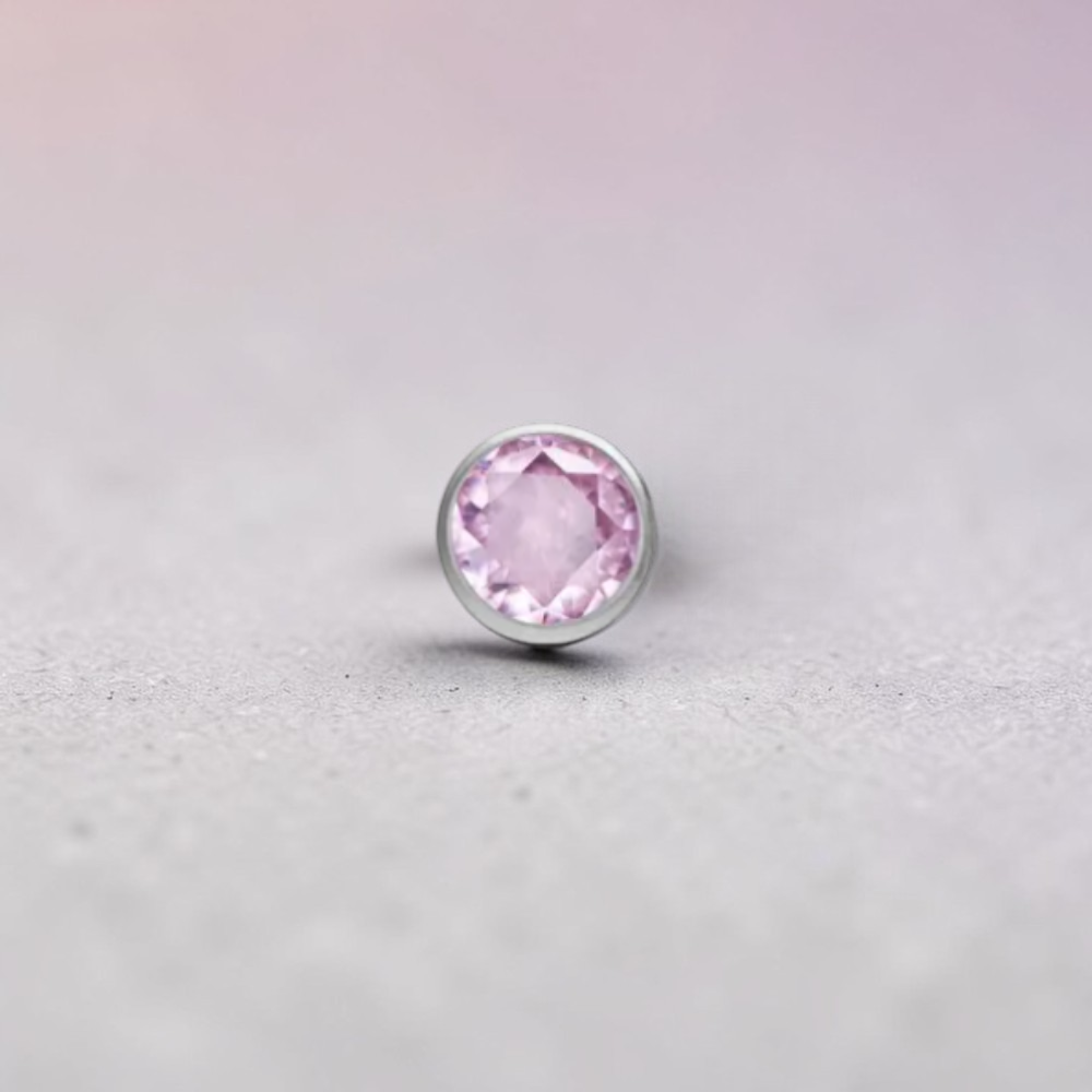 Instinct silver titanium push-in labret with small multicolor stones. Features a clear CZ stone and various colored gems.