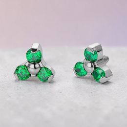 Instinct silver titanium labret top with internal thread and three green trinity stones.
