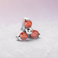 Instinct silver internally threaded labret with three orange gemstones in a trinity design.