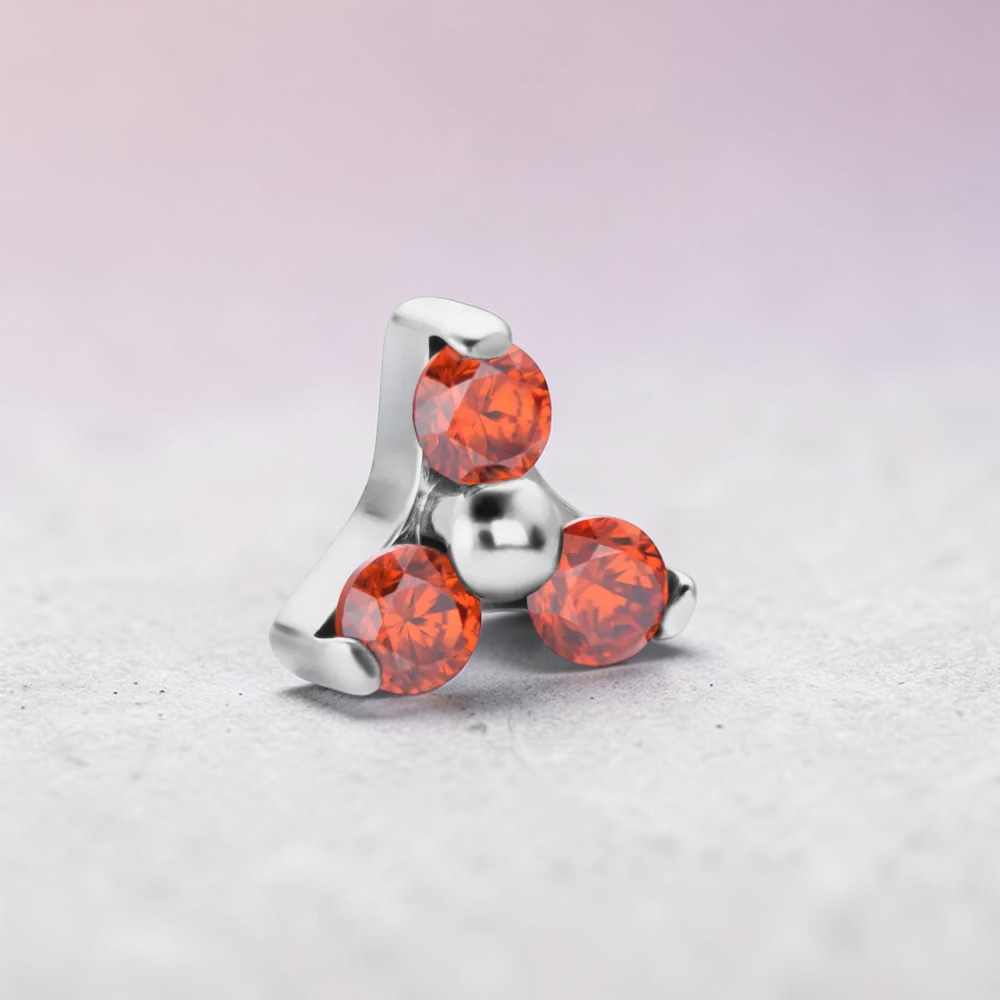 Instinct silver internally threaded labret with three orange gemstones in a trinity design.
