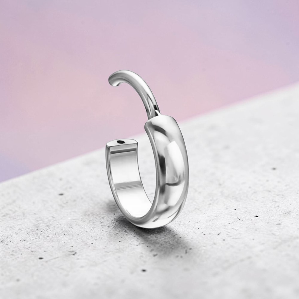 Instinct thick, round titanium hoop earrings in silver, gold, and black finishes.
