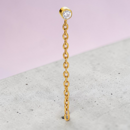 Instinct gold and silver titanium labret piercing with internal thread and a dangling chain with a clear gem.